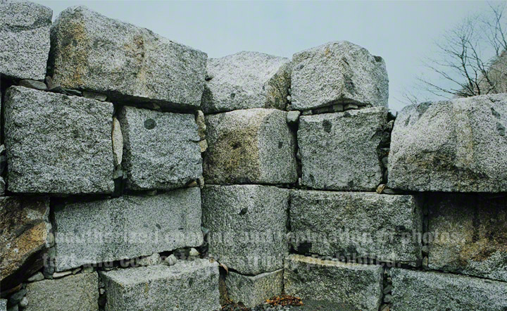 Remains of the first blast furnace. Initial test furnace, built in 1860, out of use in 1871. Dressed granodiorite masonry survives to a height of 2.4m. This stone was hewn from small quarries side in outcrops in the mountain side to the east of the Shrine.