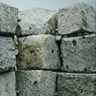 Remains of the first blast furnace. Initial test furnace, built in 1860, out of use in 1871. Dressed granodiorite masonry survives to a height of 2.4m. This stone was hewn from small quarries side in outcrops in the mountain side to the east of the Shrine.
