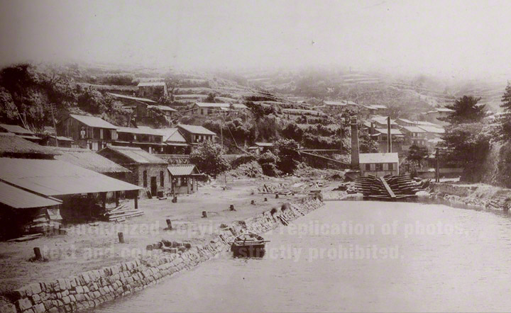 Kosuge Slip Dock is located in Nagasaki harbour on a sheltered inlet at Kosugemachi, 1 km south west of the Nagasaki foreign Settlement where Glover lived. Kosuge Slip Dock was Japan's first steam-powered Western-style slip dock, completed in January 1869.