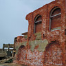 The brick wall (right in the photo) was a part of the building which housed winding engine of No. 3 shaft and was built in 1896. After No. 3 shaft was closed, it was used as a material storage.