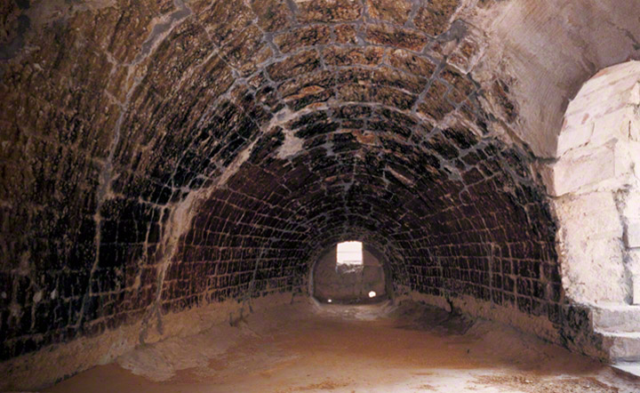 Interior of the reverberatory furnaces with firebricks (made locally). View from pig iron charging hole to tap hole.