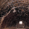 Interior of the reverberatory furnaces with firebricks (made locally). View from pig iron charging hole to tap hole.